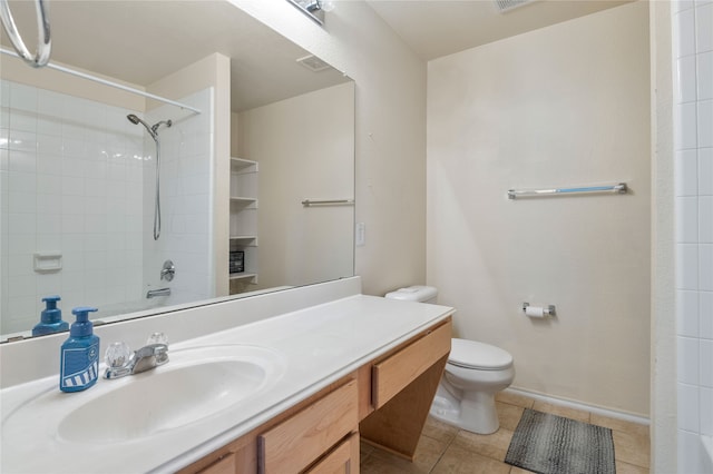 bathroom with tile floors, oversized vanity, and toilet