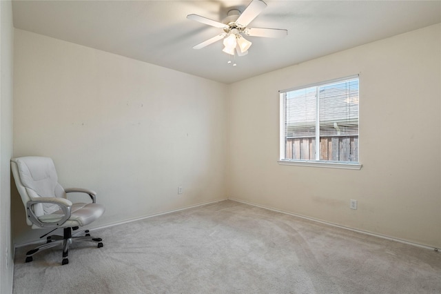 empty room with light colored carpet and ceiling fan