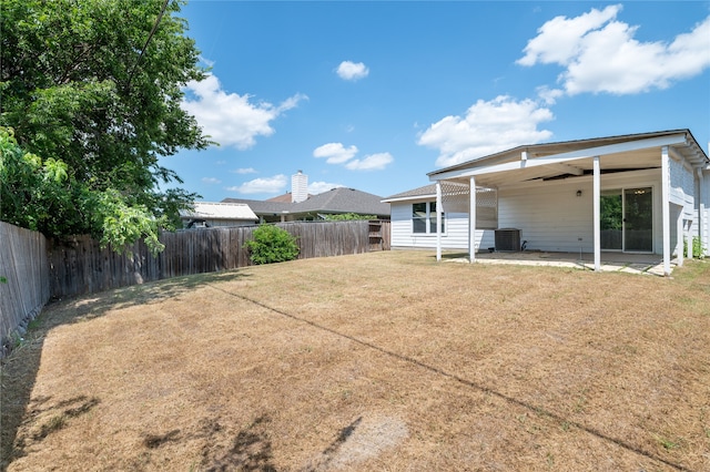 view of yard with a patio, ceiling fan, and central AC unit