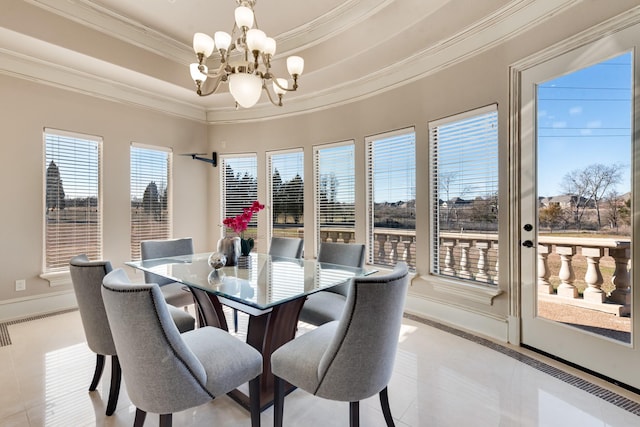 dining space featuring light tile patterned floors, crown molding, a raised ceiling, and a chandelier