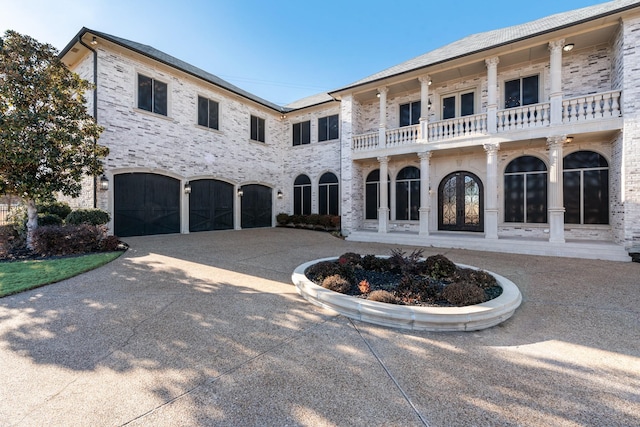 view of front of property with a balcony and a garage