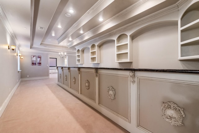 interior space with crown molding, light colored carpet, and a raised ceiling