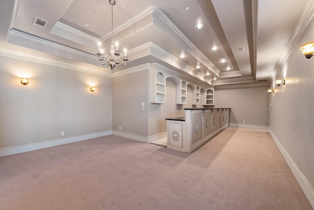 kitchen featuring light carpet, hanging light fixtures, ornamental molding, a raised ceiling, and a notable chandelier