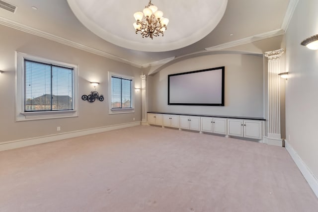 cinema featuring a raised ceiling, ornamental molding, light carpet, and a chandelier