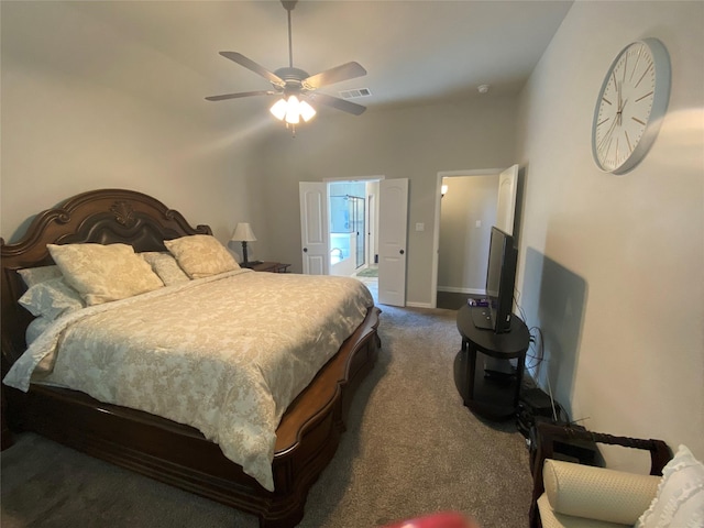 bedroom featuring carpet, vaulted ceiling, ensuite bath, and ceiling fan