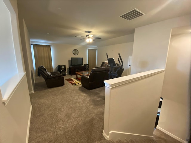 living room with dark colored carpet and ceiling fan