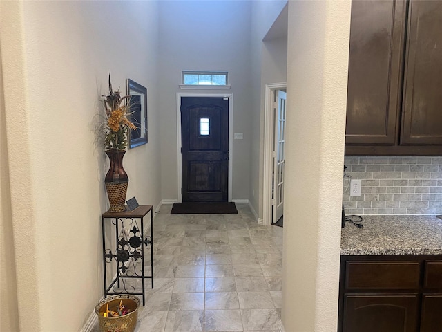 entrance foyer featuring a towering ceiling