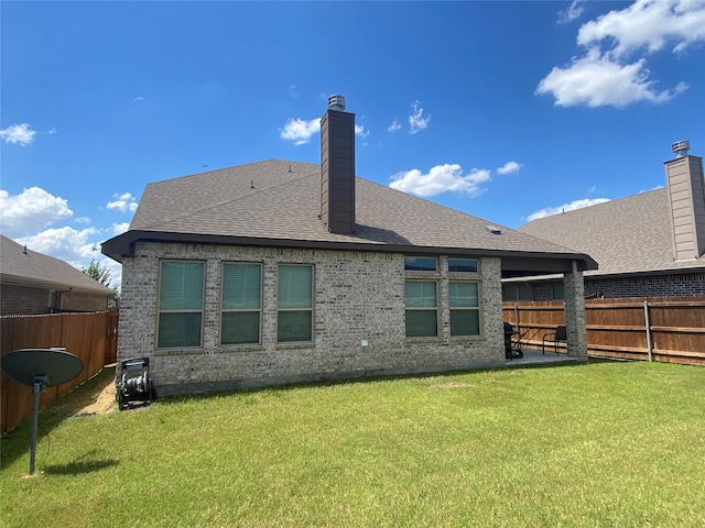 rear view of property featuring a lawn