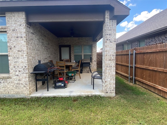 view of patio featuring ceiling fan and a grill