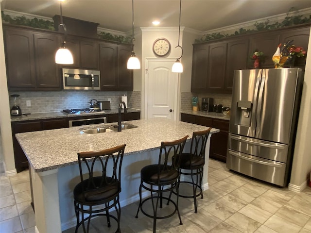 kitchen with backsplash, stainless steel appliances, dark brown cabinetry, and sink