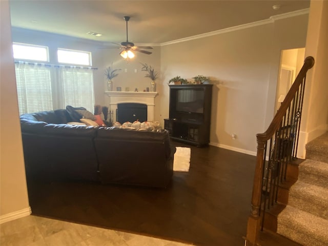 living room featuring ceiling fan and ornamental molding