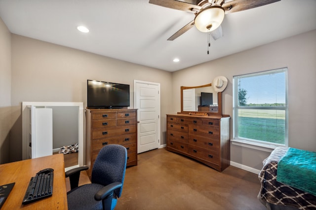 carpeted office space with ceiling fan