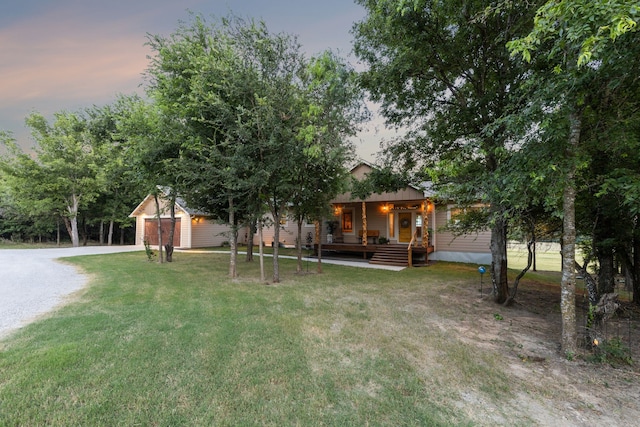 yard at dusk featuring a storage unit and a wooden deck