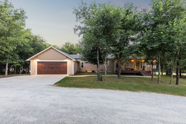 view of front of home with a yard and a garage