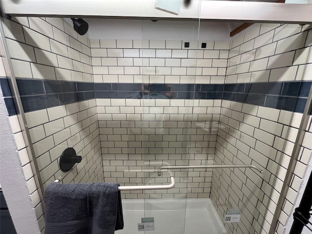 bathroom with a shower with door