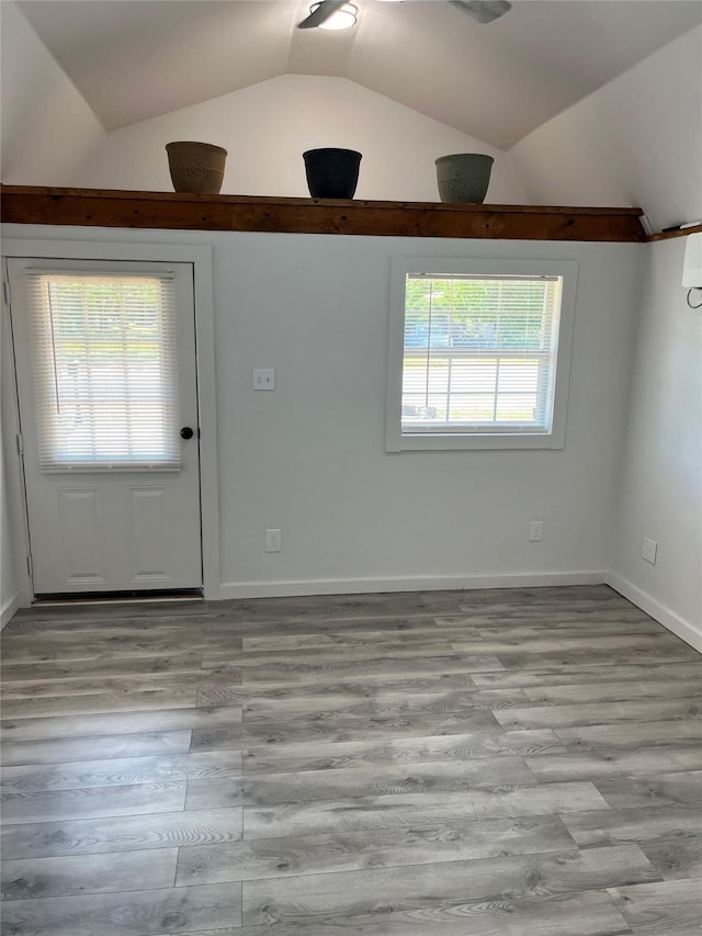 entryway with vaulted ceiling and light hardwood / wood-style flooring