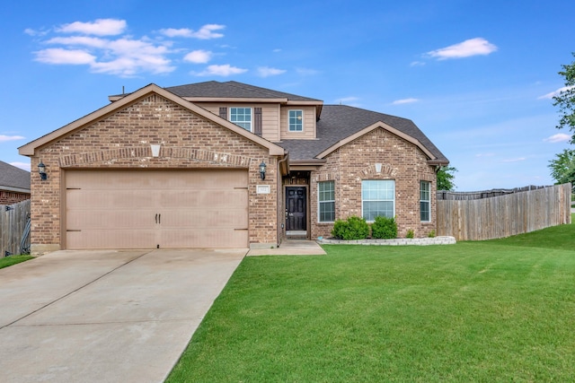 view of front of property featuring a front yard and a garage