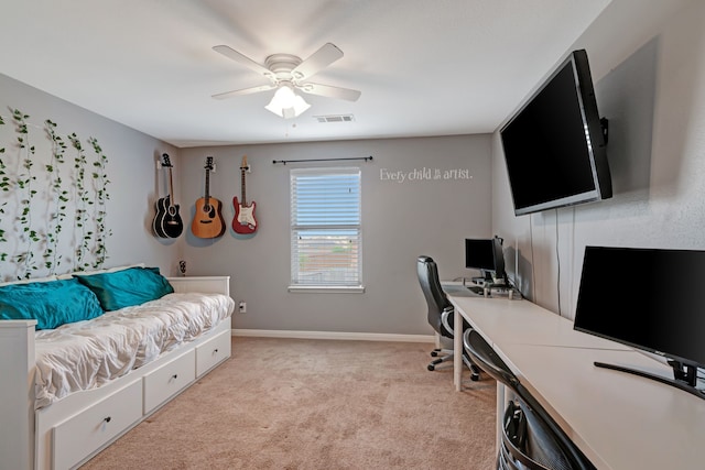 office space featuring light carpet and ceiling fan