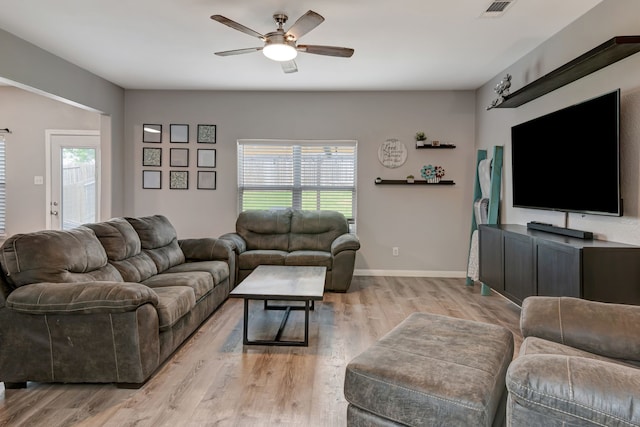 living room with ceiling fan and light hardwood / wood-style flooring