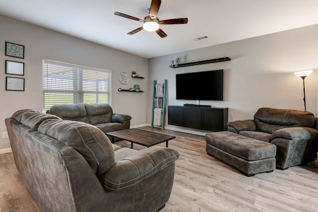 living room featuring ceiling fan and light hardwood / wood-style floors