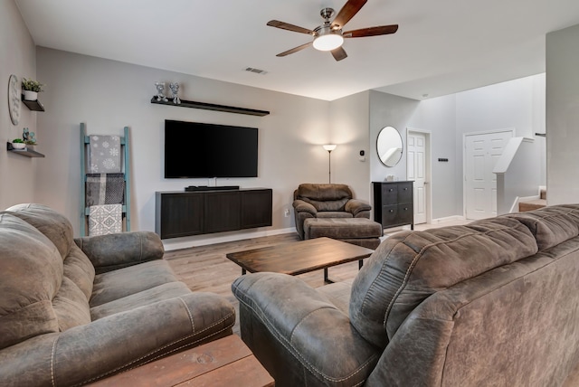 living room featuring ceiling fan and light hardwood / wood-style floors