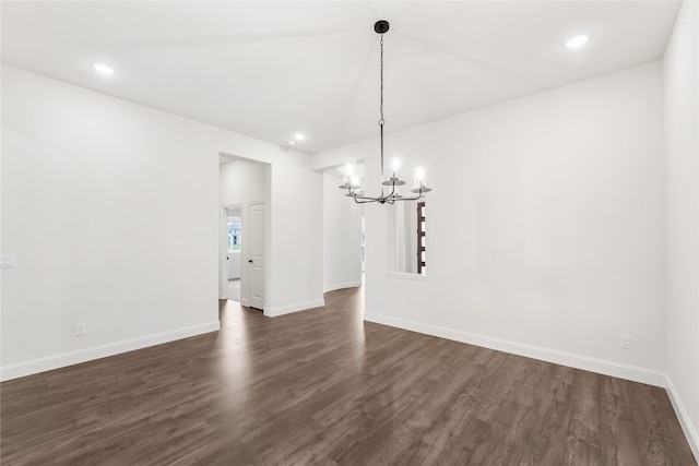 unfurnished dining area featuring dark hardwood / wood-style floors and a chandelier