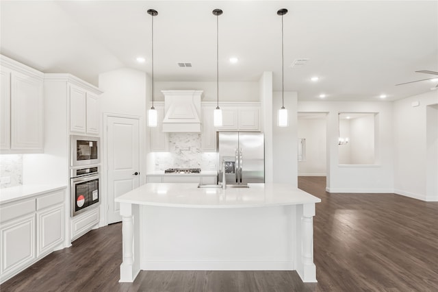 kitchen with hanging light fixtures, dark hardwood / wood-style floors, stainless steel appliances, and tasteful backsplash