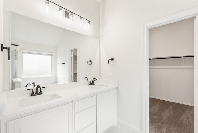 bathroom featuring vanity and vaulted ceiling