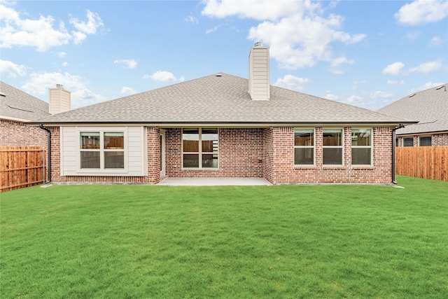 rear view of property featuring a patio and a yard