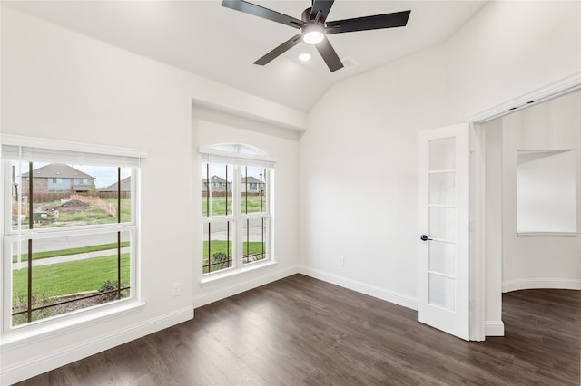 spare room featuring ceiling fan, vaulted ceiling, plenty of natural light, and dark hardwood / wood-style flooring