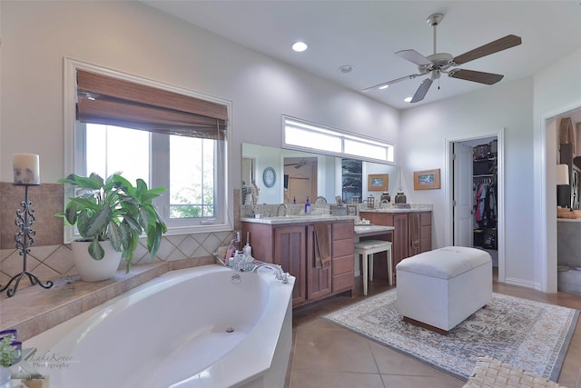 bathroom with a washtub, vanity, tile patterned floors, and ceiling fan