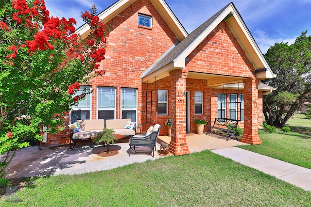 view of front of home featuring an outdoor living space, a patio, and a front lawn