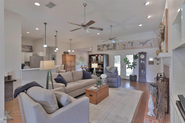 living room featuring ceiling fan, french doors, vaulted ceiling, and light hardwood / wood-style flooring