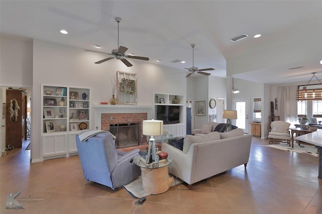 tiled living room with high vaulted ceiling, a brick fireplace, and ceiling fan