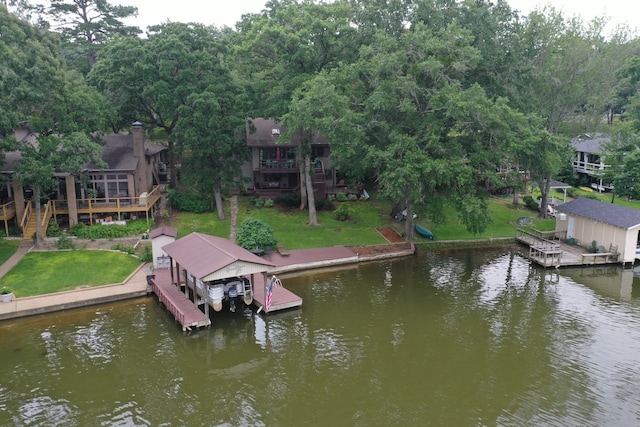 view of dock featuring a deck with water view and a lawn