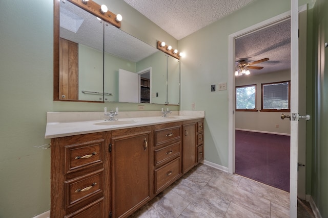 bathroom with vanity, a textured ceiling, and ceiling fan