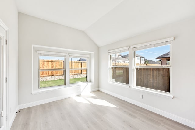 unfurnished sunroom featuring lofted ceiling