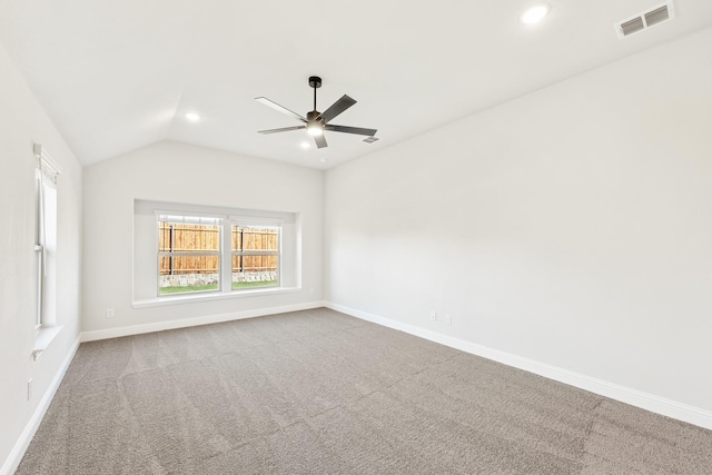 unfurnished room featuring vaulted ceiling, carpet, and ceiling fan