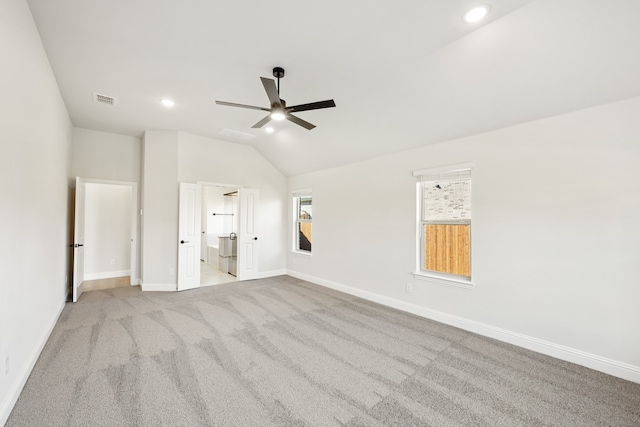 unfurnished bedroom featuring lofted ceiling, light colored carpet, and ceiling fan