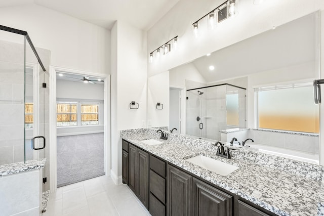 bathroom featuring lofted ceiling, vanity, tile patterned floors, and independent shower and bath