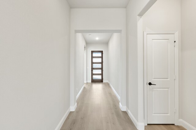 corridor with light wood-type flooring