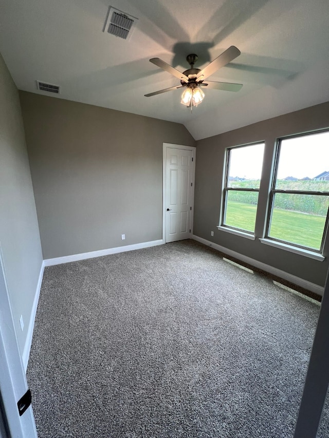 unfurnished bedroom featuring carpet floors, lofted ceiling, and ceiling fan