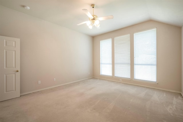 carpeted empty room featuring ceiling fan and lofted ceiling