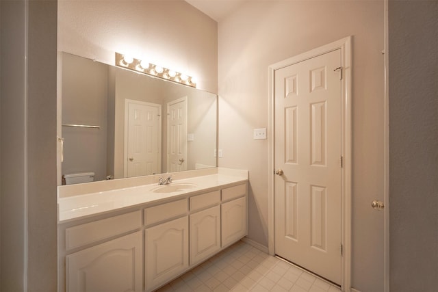 bathroom featuring tile patterned floors, vanity, and toilet