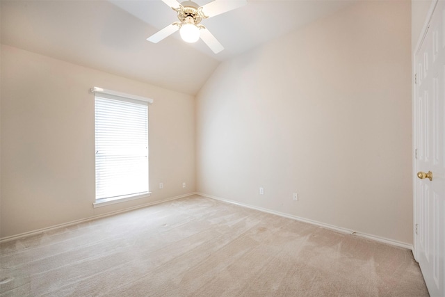 spare room with ceiling fan, light colored carpet, and lofted ceiling