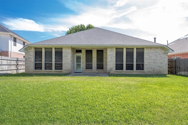 back of house with a lawn