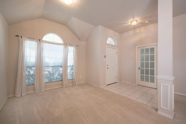 tiled entryway featuring vaulted ceiling