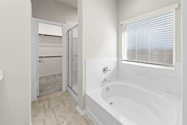 bathroom with plus walk in shower and hardwood / wood-style floors