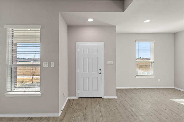 foyer entrance with light hardwood / wood-style floors