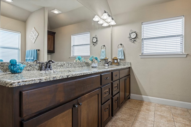 bathroom featuring vanity, tile patterned floors, and a healthy amount of sunlight